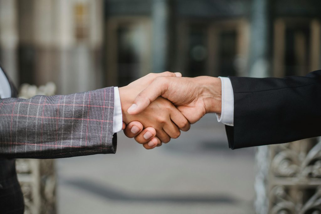 pexels-photo-4963437-4963437 Two People Shaking Hands